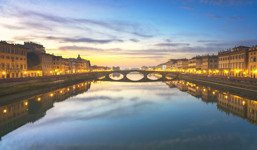 Florence, Ponte alla Carraia medieval Bridge landmark on Arno river at sunset. Tuscany, Italy.