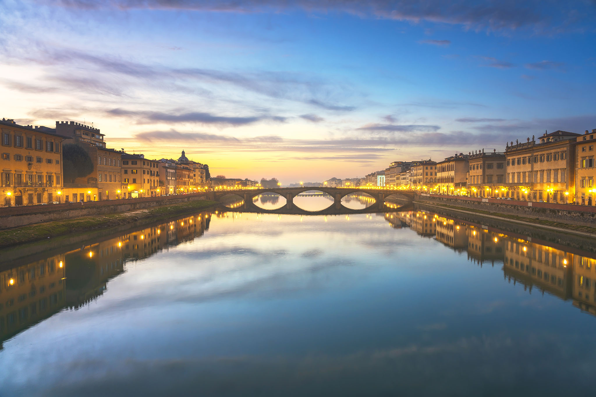 Florence, Ponte alla Carraia medieval Bridge landmark on Arno river at sunset. Tuscany, Italy.